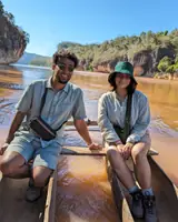 Akshat and Akanksha in a dugout canoe on a river gorge in Madagascar